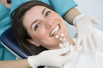 Photo of a smiling woman receiving teeth whitening in Corona, CA